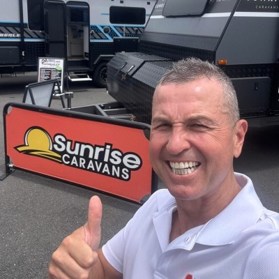 Steven Andonovski, owner of Sunrise Caravans, giving a thumbs up in the Burpengary showroom
