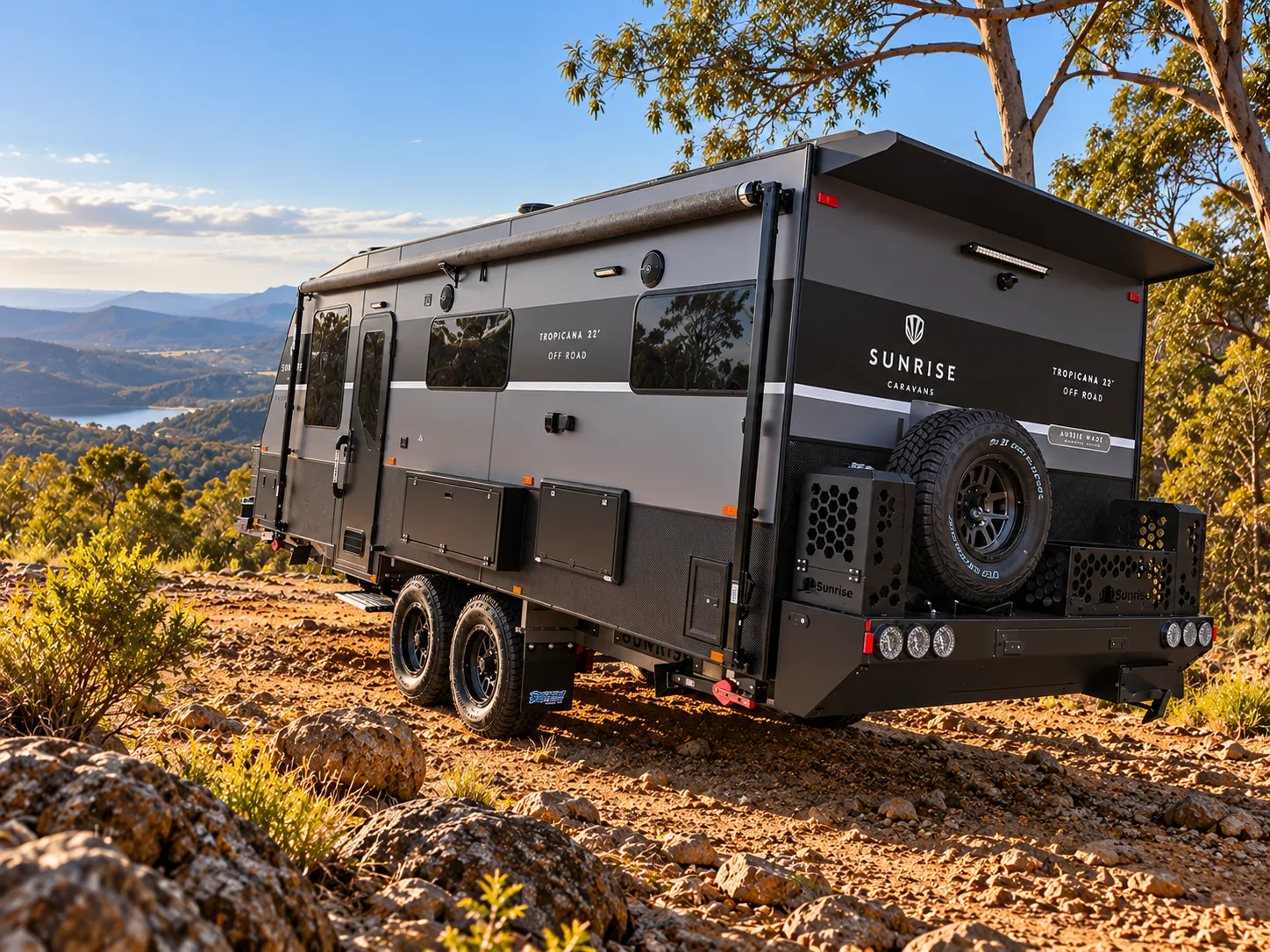Sunrise Tropicana 22ft off road caravan parked on a rocky hilltop at sunset
